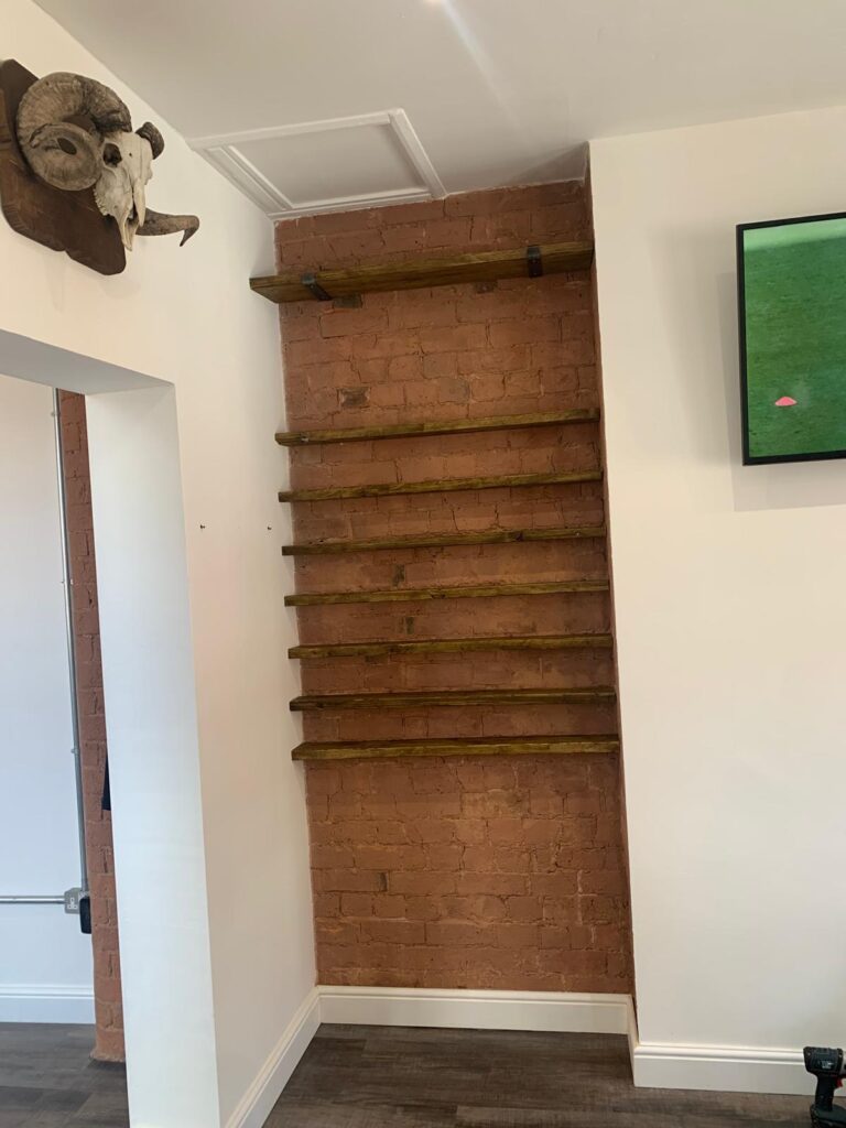Brick interior wall featuring wooden breakfast bar ledge
