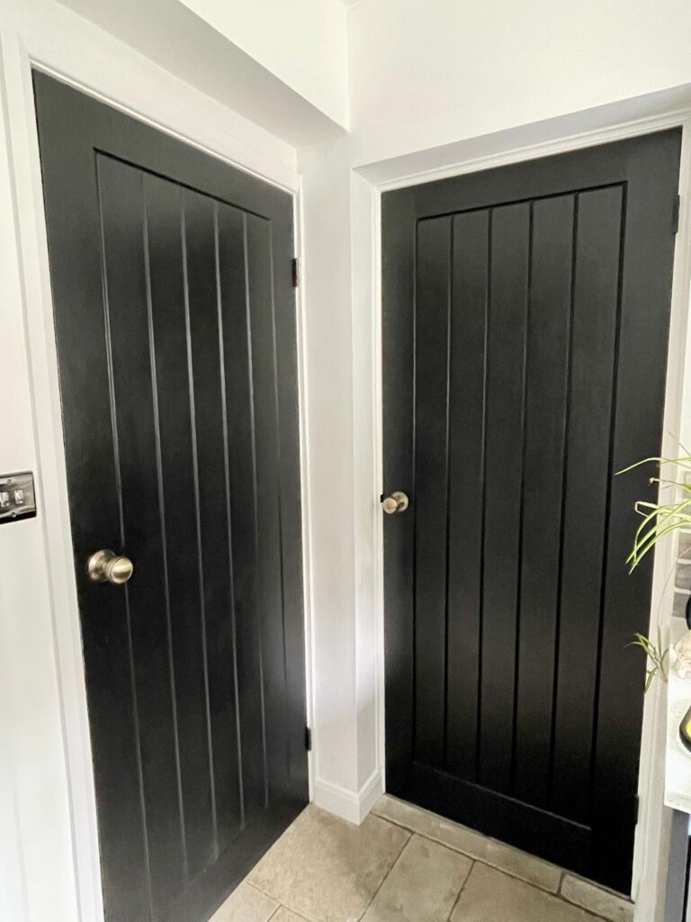 Custom black timber door with modern silver hardware