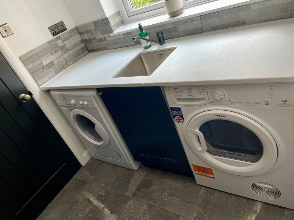 White quartz countertop with undermount sink in utility room