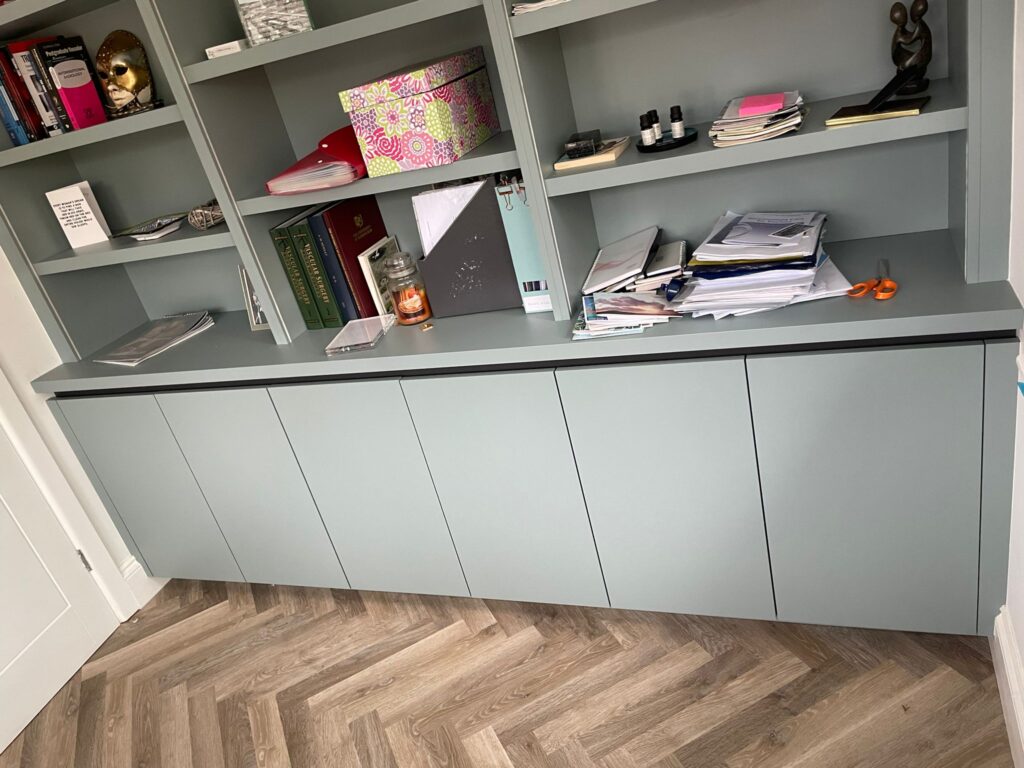 Sage green bespoke floor to ceiling library and shelving unit